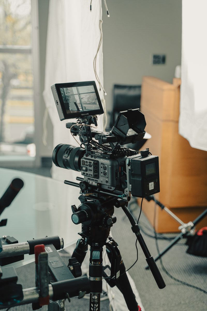Documentary-style corporate interview production at the Little Rock Chamber of Commerce with professional crew, lighting, and overhead diffusion