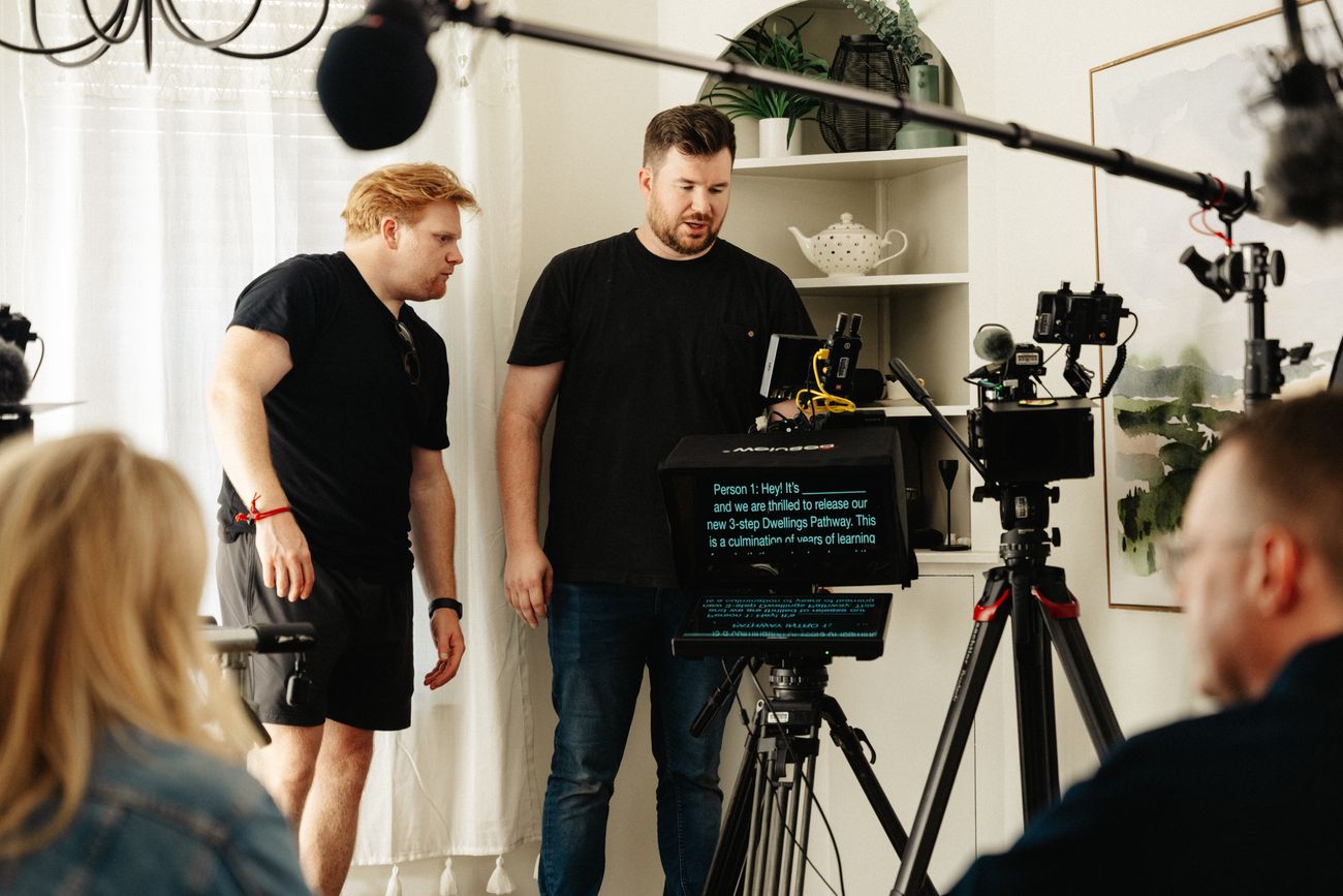 Production crew lead and camera operator reviewing setup during a corporate video shoot in Arkansas