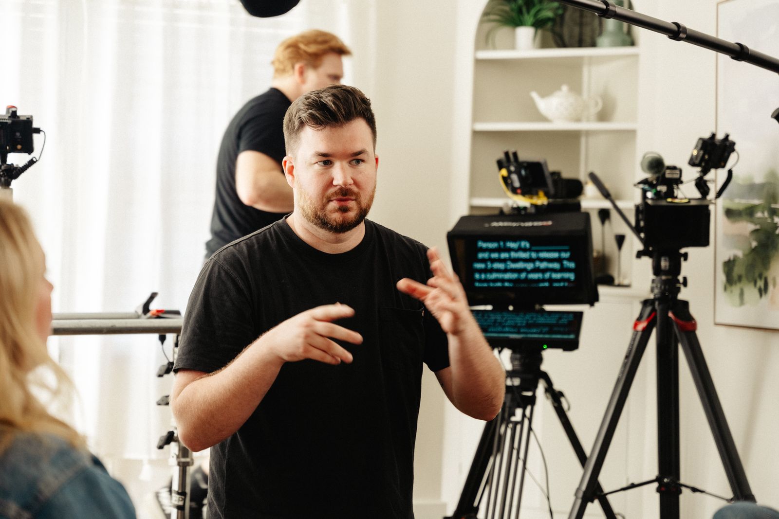 Video production crew reviewing teleprompter script and camera setup before shooting a corporate interview in Arkansas