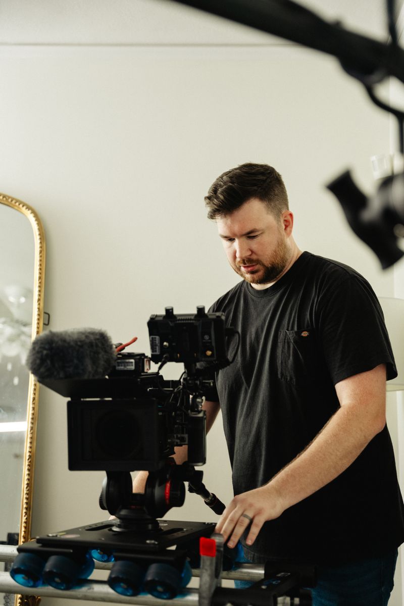 Director and cinematographer discussing camera setup during a corporate video production in Arkansas