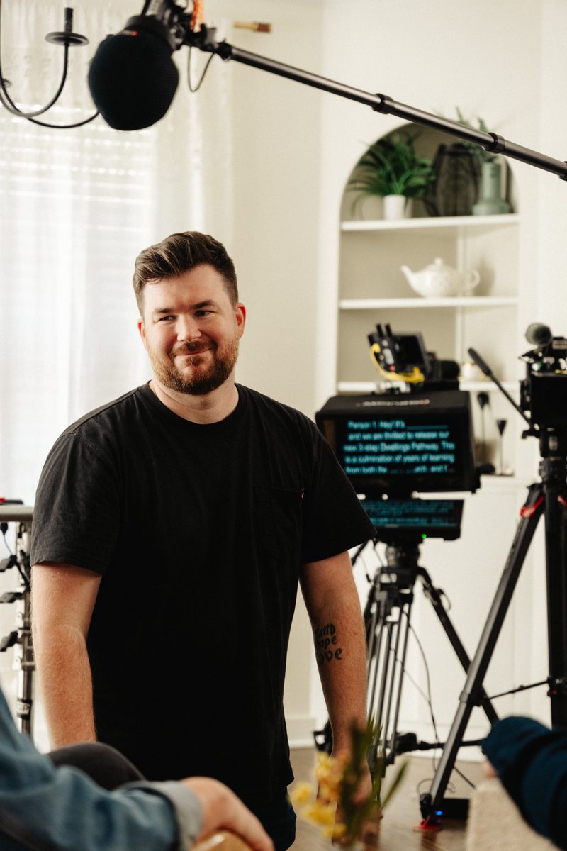 Director coaching on-camera talent during a corporate video shoot in Arkansas with cinema camera and teleprompter setup visible