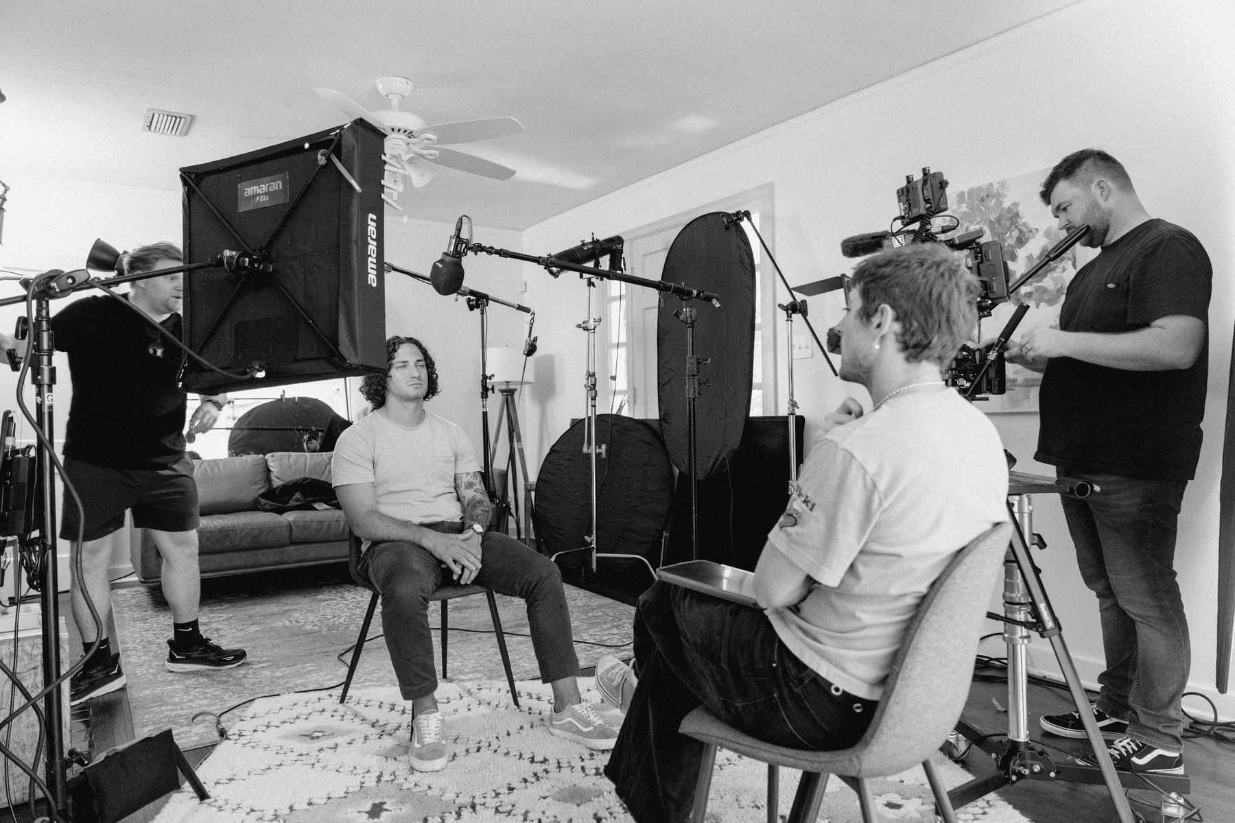Director and client reviewing live video feed on a production monitor during a corporate video shoot in Arkansas