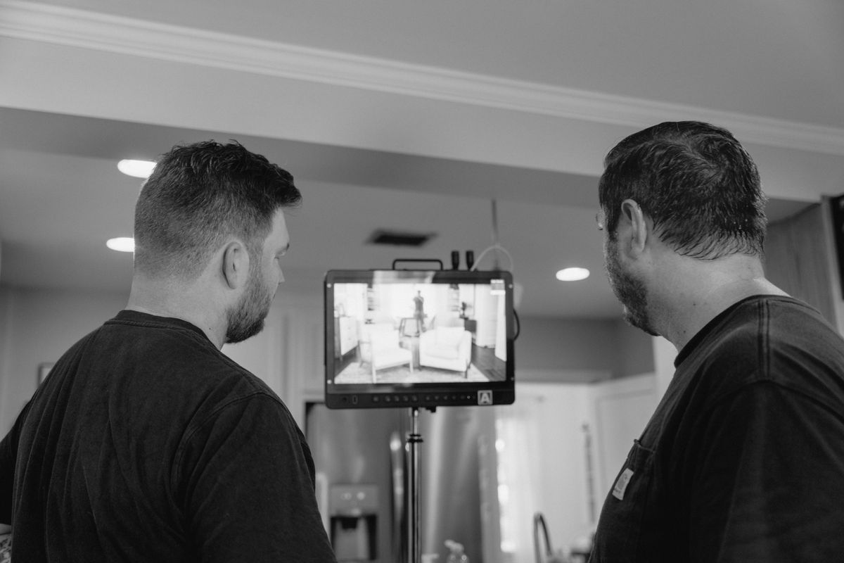 Director operating a professional cinema camera with TILTA rig during a corporate video shoot in Arkansas