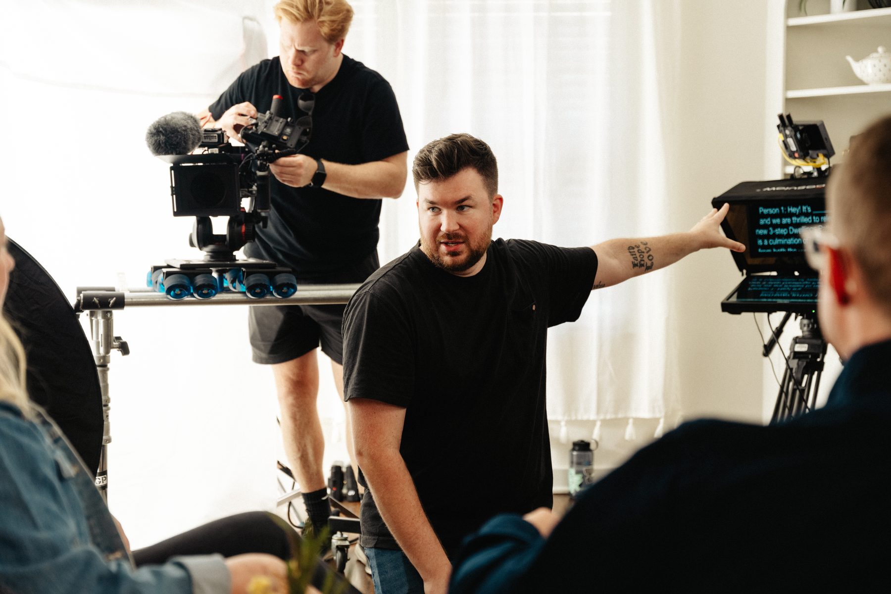Paul, owner of aPauling Productions, directing talent on a corporate video shoot in Arkansas with cinema camera and teleprompter visible