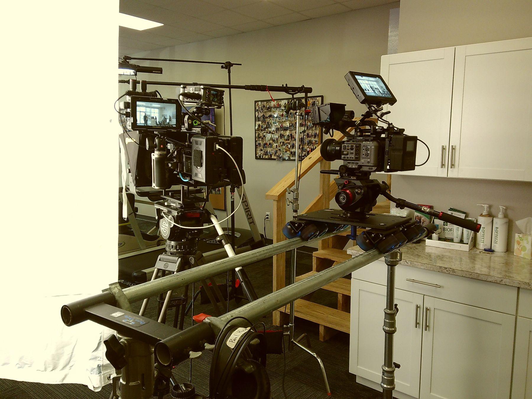 A dual-camera professional video production setup with dolly and monitors on a corporate shoot in Arkansas